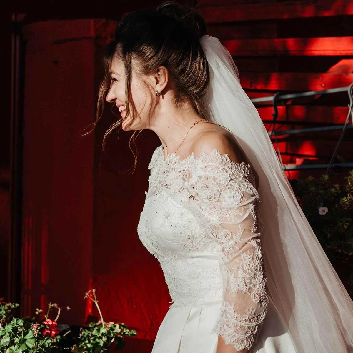 Bride wearing a lace wedding dress with long sleeves and a veil