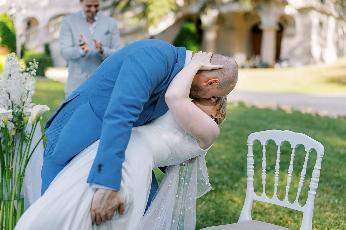 Bride and groom sharing a playful embrace outdoors