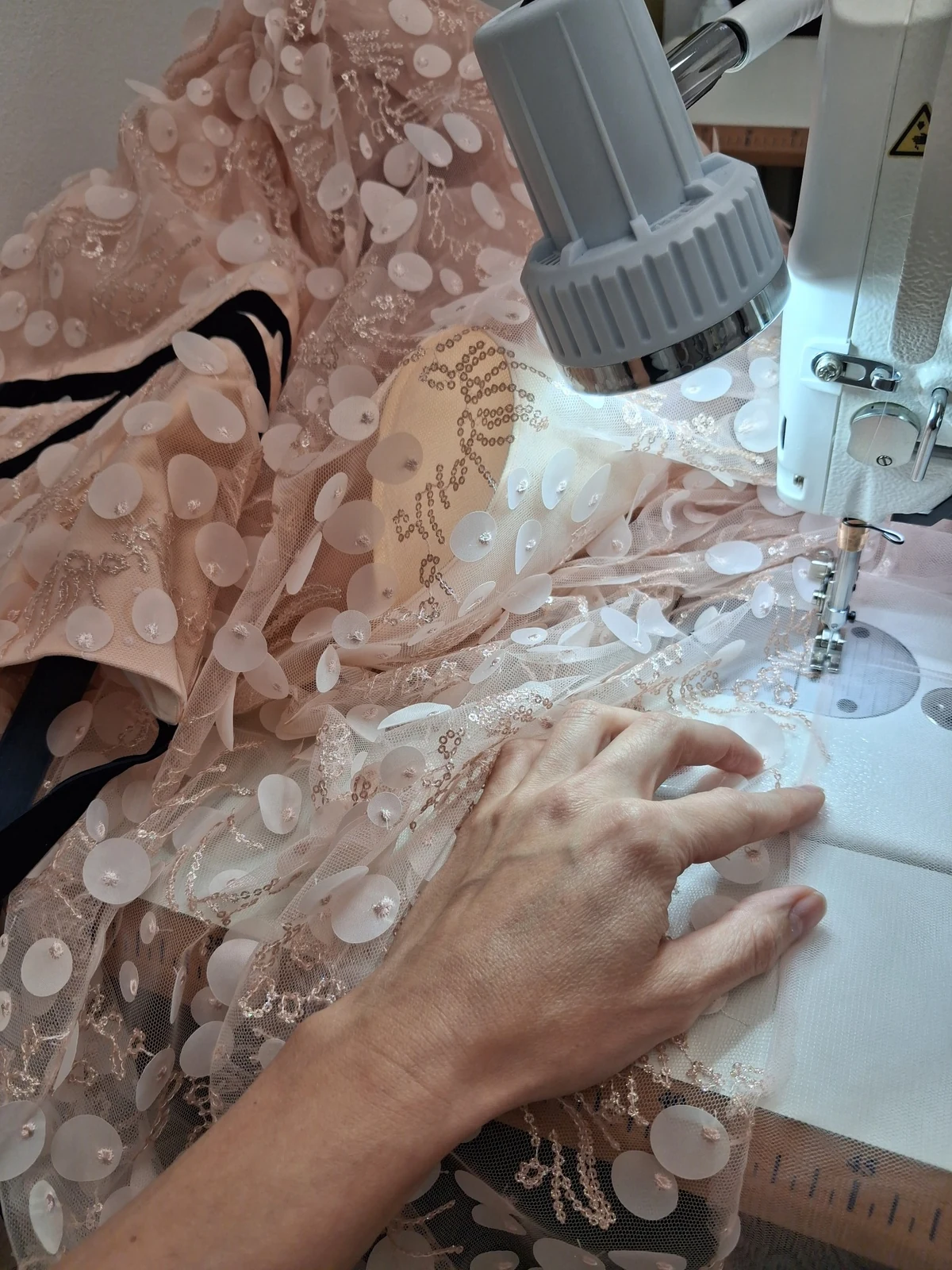 Working on the embroidery and three-dimensional appliqués of Shira Fuchs’s couture gown in the FRILISA atelier